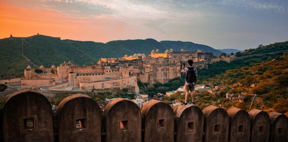 Jaipur Jodhpur Jaisalmer tour — camel caravan silhouette against golden sunset at Sam Sand Dunes Thar Desert Rajasthan