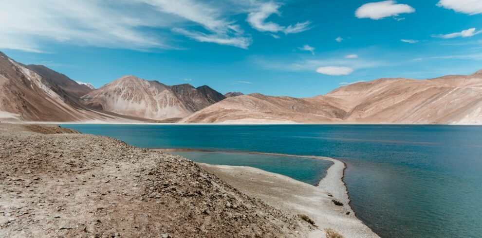 Leh Ladakh tour panoramic view of Pangong Lake with blue water and snow-capped Himalayan mountains