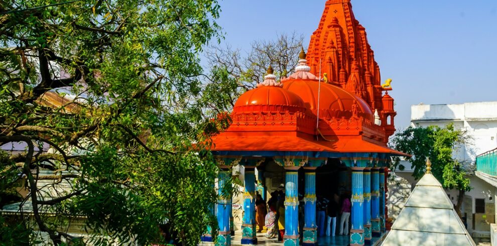 Rajasthan religious tour — Khatu Shyam Ji temple decorated facade with devotees offering flowers Sikar district