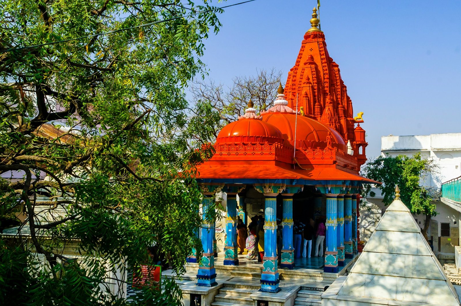 Rajasthan religious tour — Khatu Shyam Ji temple decorated facade with devotees offering flowers Sikar district