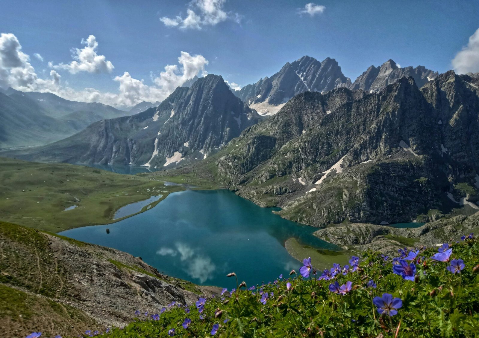 Kashmir tour package houseboat on Dal Lake at sunrise with Zabarwan mountains