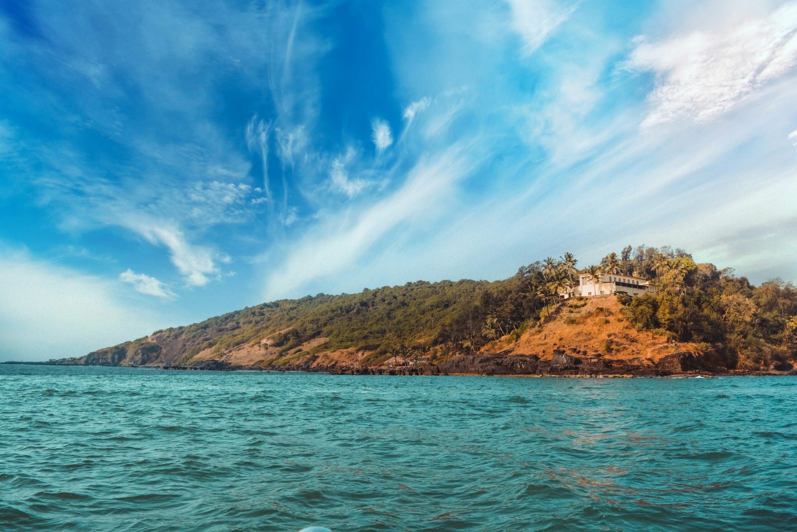 Budget Goa package — Baga Beach North Goa golden shore palm trees tourists and beach shacks aerial view
