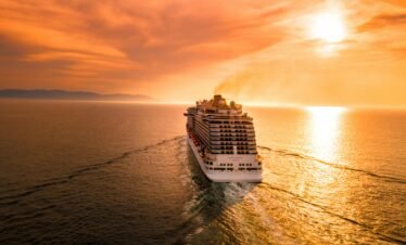 Goa group package — large group tourists on private coach boarding Mandovi River sunset cruise Goa