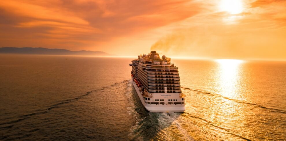 Goa group package — large group tourists on private coach boarding Mandovi River sunset cruise Goa