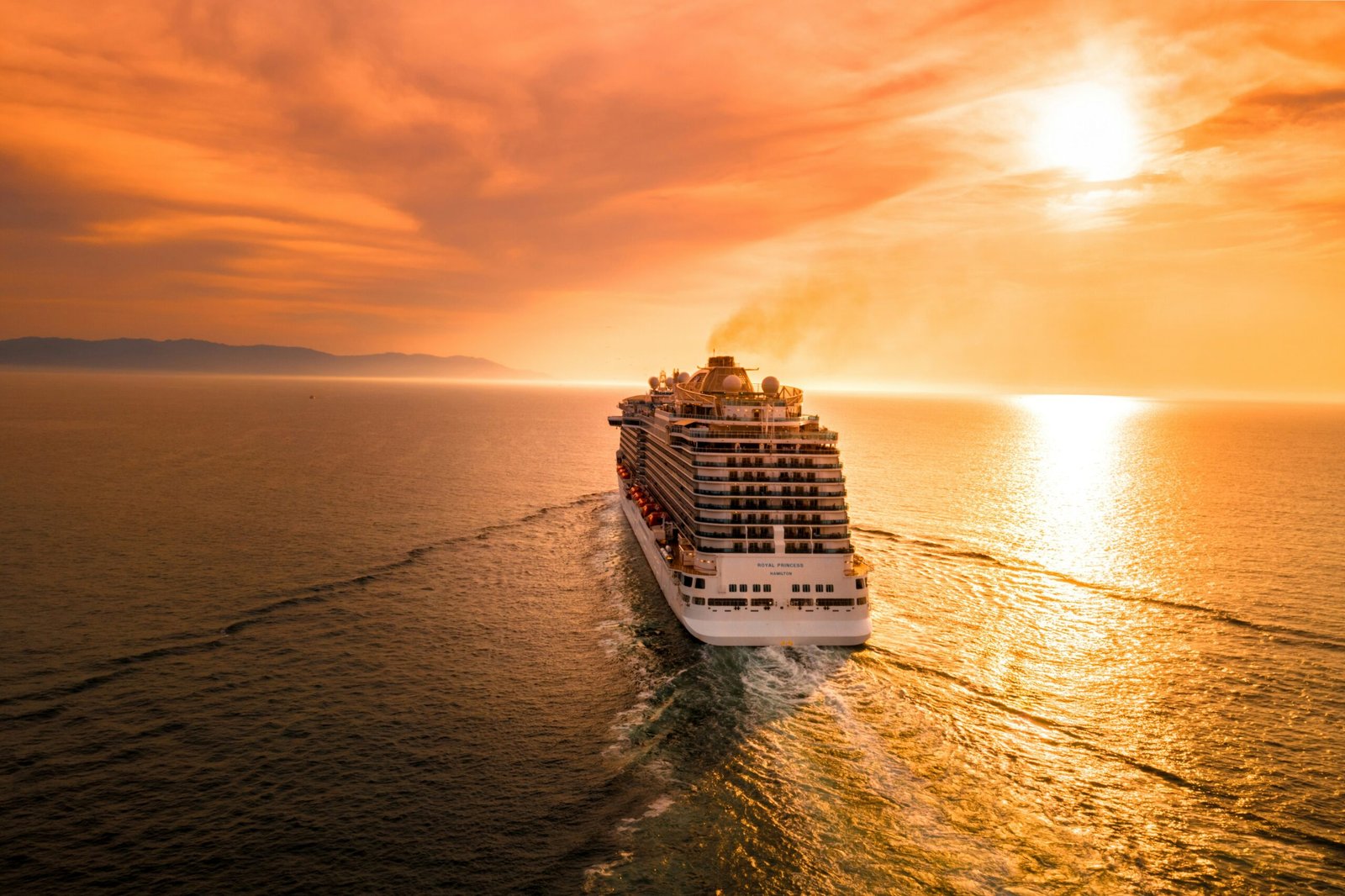 Goa group package — large group tourists on private coach boarding Mandovi River sunset cruise Goa